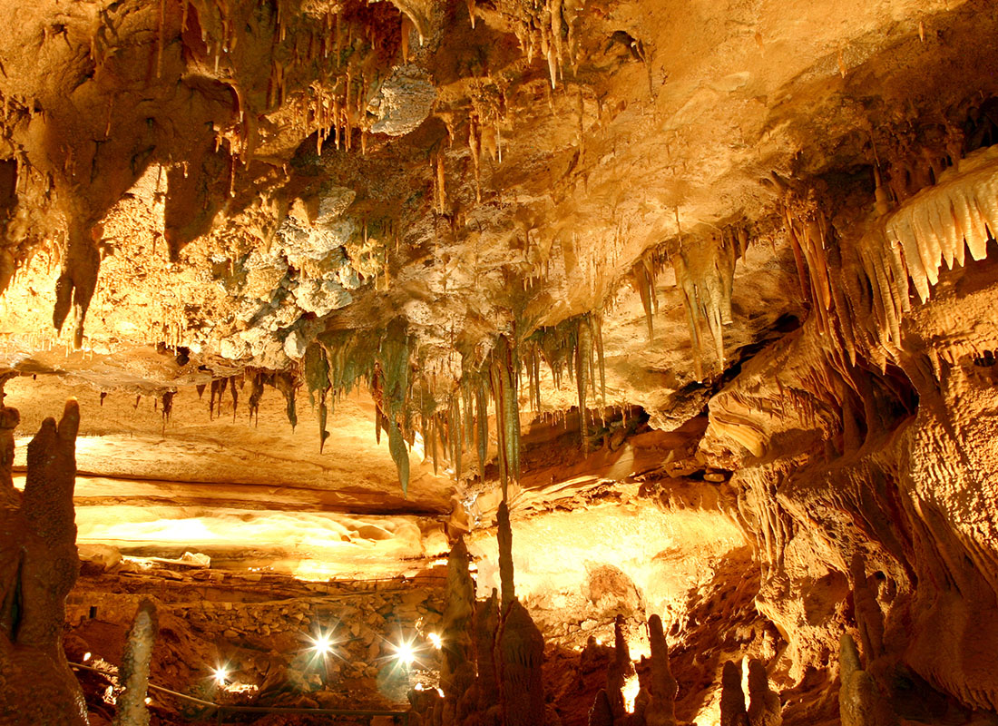 Georgetown, TX - Inside a Cave With Flashlights Shining Bright onto Stalagmites