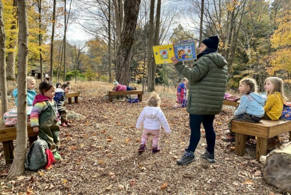 Group of kids learning in woods, engaging with nature to reduce screen time effects