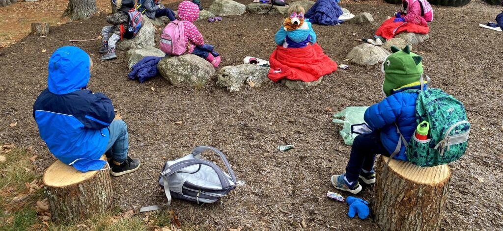 Students participating in outdoor activities during back-to-school time in a wooded area